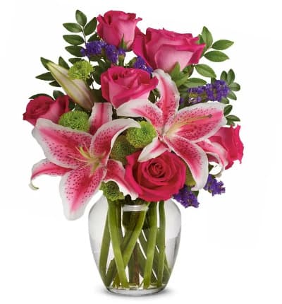 * Pink Roses
* Pink Stargazer Lilies
* Green Button Spray Chrysanthemums
* Purple Seafoam Statice
* Huckleberry
* Glass Vase