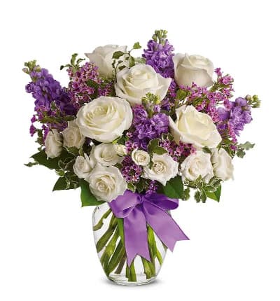 * White Full-Size Roses
* White Spray Roses
* Lavender Stock & Waxflower
* Lavender Satin Ribbon
* Glass Vase