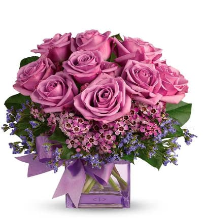 * Purple Roses
* Seasonal Greens
* Square Glass Vase
* Purple Ribbon
