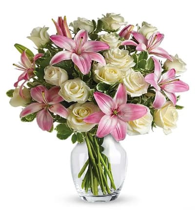 * One Dozen White Roses
* Pink Asiatic Lilies
* Variegated Pittosporum
* Glass Vase