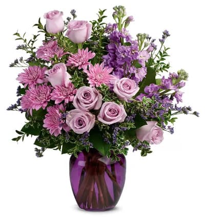 The perfect pick for the purple lover in your life! This impressive bouquet charms anyone who gazes upon its whimsical blend of lavender roses, stock and mums. It is presented in a gorgeous glass vase and measures approximately 18