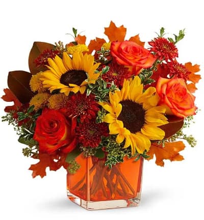 * Orange Roses
* Yellow Sunflowers
* Gold Cushion Poms
* Rust Cushion Mums
* Seeded Eucalyptus
* Oregonia
* Magnolia Leaves
* Keepsake Orange Cube Vase