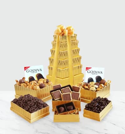 Velvety chocolate abounds in this gold tower of Godiva riches. Our dazzling tower is overflowing with sumptuous chocolates for a truly spectacular treat. Satisfy that chocolate craving with an assortment of Godiva chocolate truffles, chocolate-covered pretzels, a signature gold Godiva box of assorted chocolates, Godiva signature biscuits, and dark chocolate almonds. It's the height of indulgence.

Includes:
* Godiva Chocolate Truffles
* Godiva Chocolate Covered Pretzels
* Box of an Assortment of Godiva Chocolate
* Godiva Signature Biscuits
* Godiva Dark Chocolate Almonds
* 4 Gift Boxes